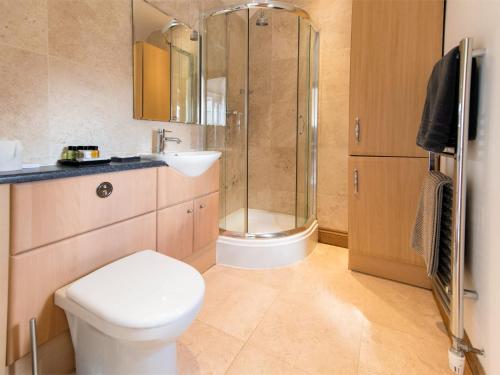 a bathroom with a shower and a toilet and a sink at 1 Bed in Knaresborough HH102 in Knaresborough