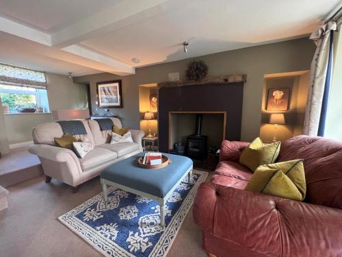 a living room with two couches and a fireplace at 2 Bed in Pateley Bridge G0017 in Lofthouse