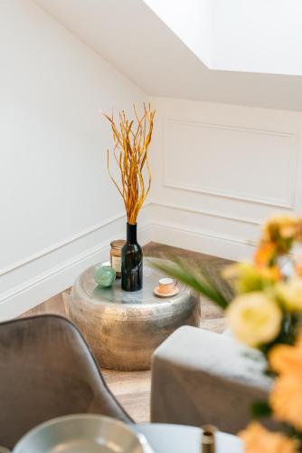 a table with a vase on top of a table at Central Palace - LoftAffair Collection in Kraków
