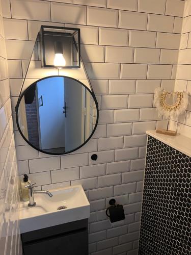 a bathroom with a mirror and a sink at Short Stay house in Groningen in Groningen