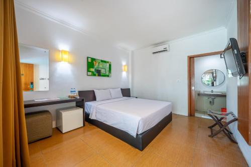 Кровать или кровати в номере Spazzio Bali Hotel