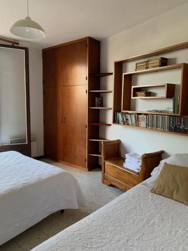 a bedroom with a bed and a chair and a cabinet at Maison Les Mimosas in Rayol-Canadel-sur-Mer