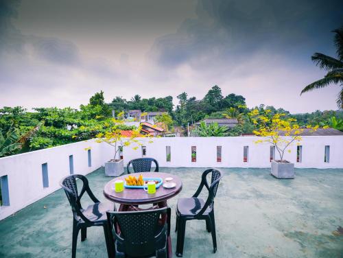 a table and chairs on the roof of a house at Annasi Villa in Hikkaduwa