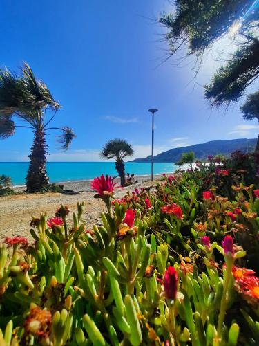 a garden of flowers with the ocean in the background at Gorgeous SeaView house in Pissouri