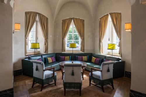a living room with a couch and a table at Falkensteiner Schlosshotel Velden – The Leading Hotels of the World in Velden am Wörthersee