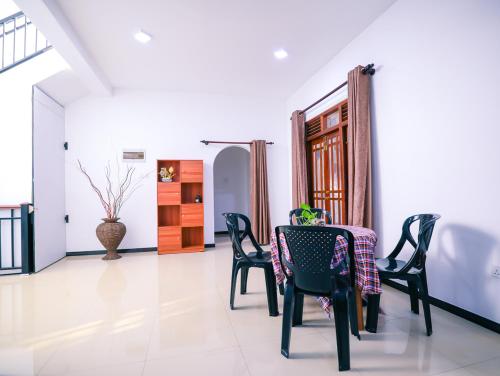 a dining room with a table and chairs at Annasi Villa in Hikkaduwa