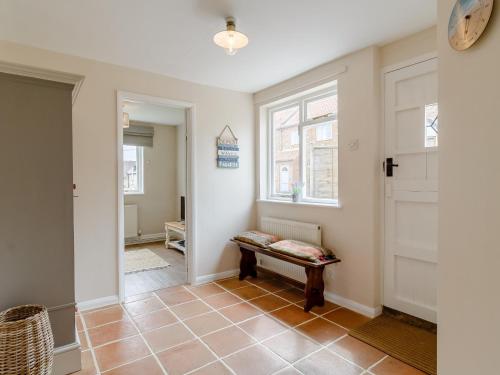 a hallway with a bench and a window at 3 Bed in Old Hunstanton 78821 in Hunstanton