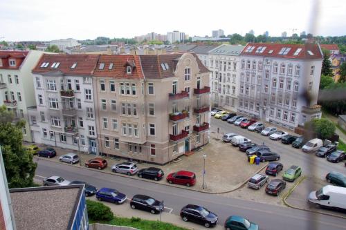 una vista de una ciudad con coches aparcados en un aparcamiento en Ferienwohnung "Am Vögenteich" en Rostock