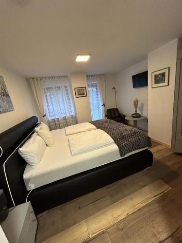 a bedroom with a large bed in a room at Haus zum guten Hirten in Steinsfeld