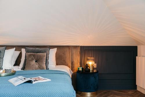 a bedroom with a bed with a blue comforter at Central Palace - LoftAffair Collection in Kraków