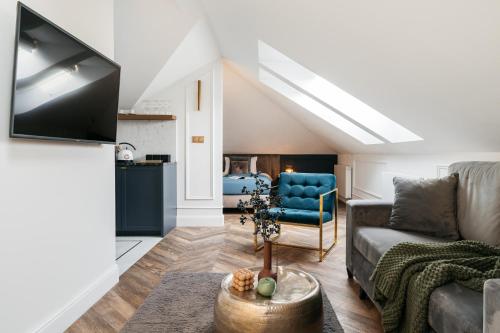 a living room with a couch and a chair at Central Palace - LoftAffair Collection in Kraków