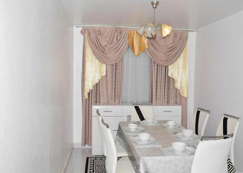 a dining room with a table and chairs at Dolly Apartments in Nairobi