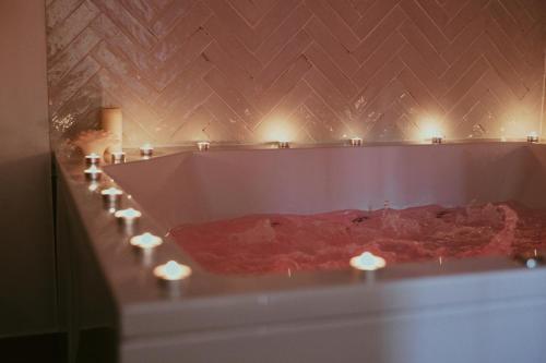 a bath tub with candles in it with lights at Luxury Jacuzzi Apartment in Mostar