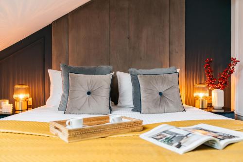 a hotel room with a bed with a tray on it at Central Palace - LoftAffair Collection in Kraków