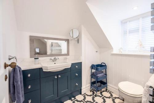 a bathroom with a sink and a toilet at Gulls' Nest, Felixstowe in Felixstowe