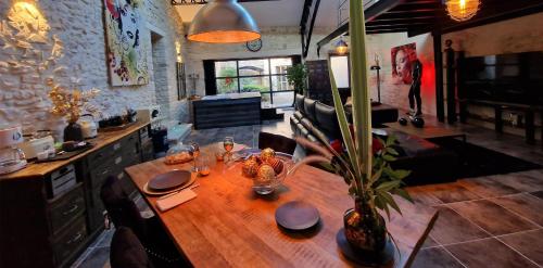 a wooden table in a room with a dining room at Demeure de la Baronne in Vézénobres