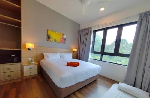 a bedroom with a white bed and a large window at Ipoh Sunway Onsen Suites and Tambun Guesthouse , 3-14pax 2parking by IWH in Ipoh