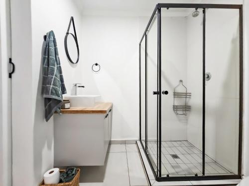 a bathroom with a shower and a sink at Micro Urban Oasis in Pretoria