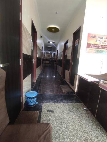 a hallway in a building with a blue bucket at Nidhivan Dhaam in Mathura