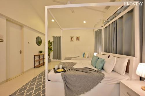 a bedroom with two beds and a large window at EKOSTAY - Water Lagoon Villa in Lonavala