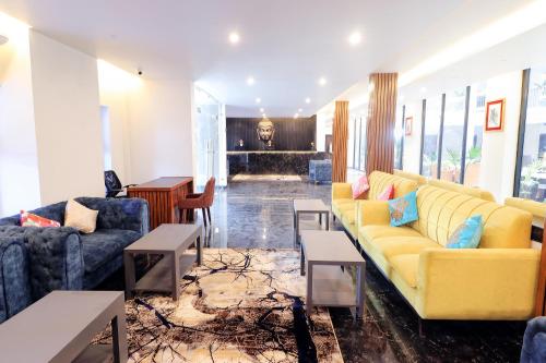 a living room with two couches and a table at Landmark Bhairahawa in Bhairāhawā
