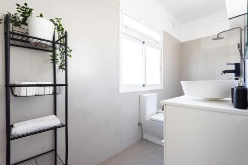 a white bathroom with a sink and a toilet at Home2Book Stylish & Bright Apt, Santa Cruz Center in Santa Cruz de Tenerife