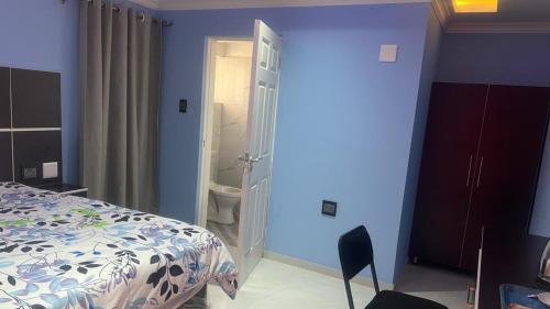 a bedroom with a bed and a bathroom at Goldwell airport Lodge in Kempton Park