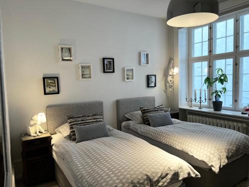a bedroom with two beds and a window at Camillas Holiday home Copenhagen City Centre in Copenhagen