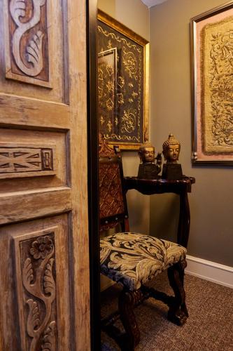 a room with a door with a chair and a table at Faik Pasha Hotels Special Category Beyoglu Istanbul in Istanbul