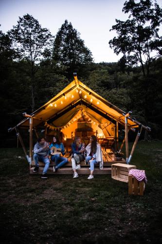 a group of people sitting in a tent at Ca Stella Camping del Monte San Giorgio in Meride