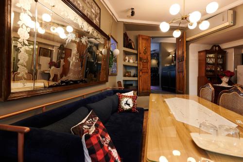 a living room with a blue couch and a table at Faik Pasha Hotels Special Category Beyoglu Istanbul in Istanbul
