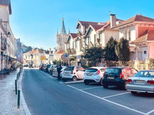 een straat met auto's geparkeerd op een parkeerplaats bij Happy Holiday Sintra in Sintra