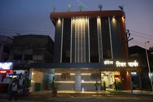 a building with a sign that reads first first unit at Hotel River Park in Navi Mumbai