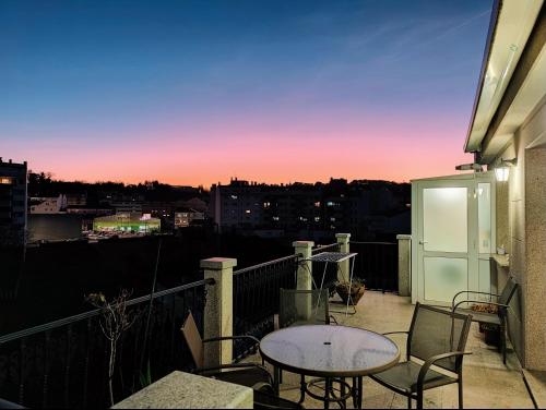 a patio with a table and chairs on a balcony at Casa-Nova in Sarria