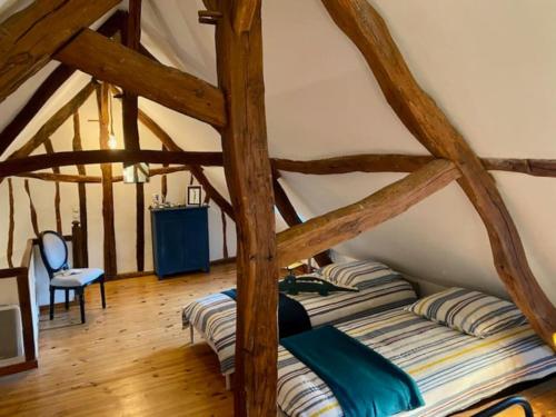 - une chambre avec 2 lits dans une chambre dotée de parquet dans l'établissement Gite des Capucins, 6 personnes, Centre Historique, aux Andelys