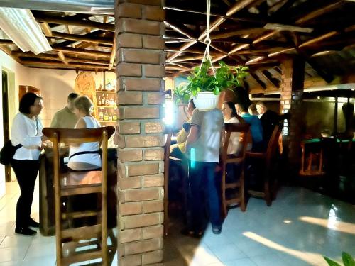 a group of people sitting at a table in a restaurant at Home Feeling Neneu Lodge in Moshi