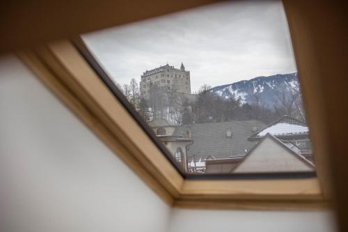 a view of a castle from a window at Avia Living Maria in Brunico