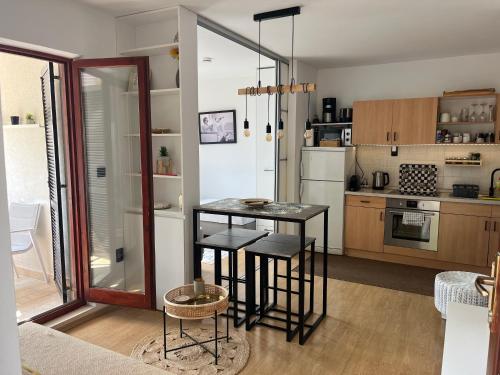 a kitchen with a table and chairs in a room at Sara Brela Apartment in Brela