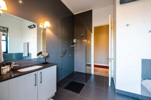 a bathroom with a sink and a shower at Farm Stay Winelands in Paarl