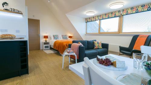 a living room with a bed and a couch at Ty Haul in Llanfaelog