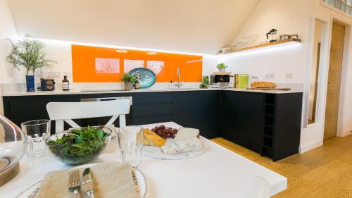 a kitchen with a table with a bowl of food on it at Ty Haul in Llanfaelog
