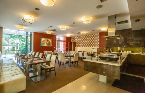 a dining room with tables and chairs in a restaurant at IMPIQ Hotel in Trnava