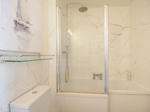 a white bathroom with a shower and a toilet at 1 Bed in Hythe 89968 in Hythe