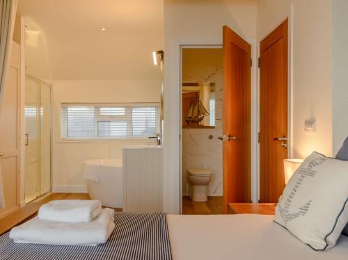 a bathroom with a bed and a tub and a toilet at 1 Bed in Hythe 89970 in Hythe