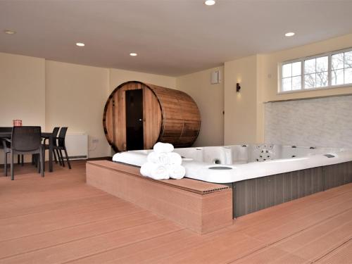 a large bathroom with a tub and a barrel at 7 Bed in Exmoor 83059 in Parracombe