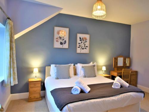 a bedroom with a large bed with blue walls at 7 Bed in Exmoor 83059 in Parracombe