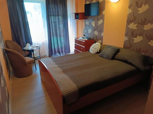 1 dormitorio con 1 cama, 1 silla y 1 ventana en Pokoje Gościnne Wanda, en Władysławowo