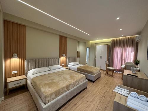 a hotel room with two beds and a desk at Arial Lofts in Vlorë
