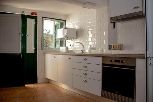 a kitchen with a sink and a counter top at Casa do Riu in Santiago de Montalegre