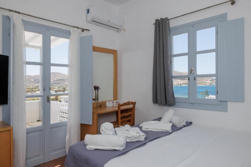 a room with a bed with white towels on it at Maryo Village in Naousa